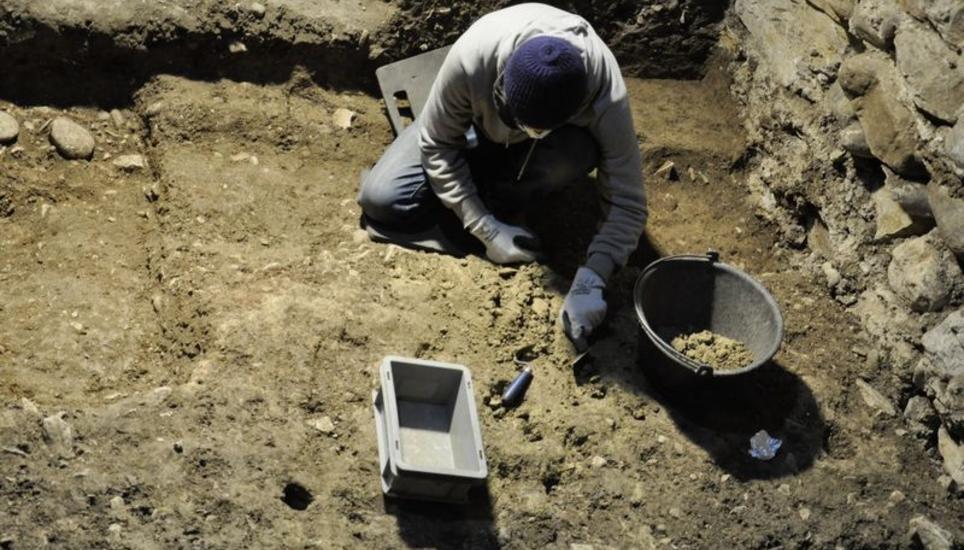 In sorgfältiger Handarbeit wird der Boden nach archäologischen Überresten durchsucht. Gefundene Tonscherben lassen dabei auf die jeweilige Zeitepoche schliessen.