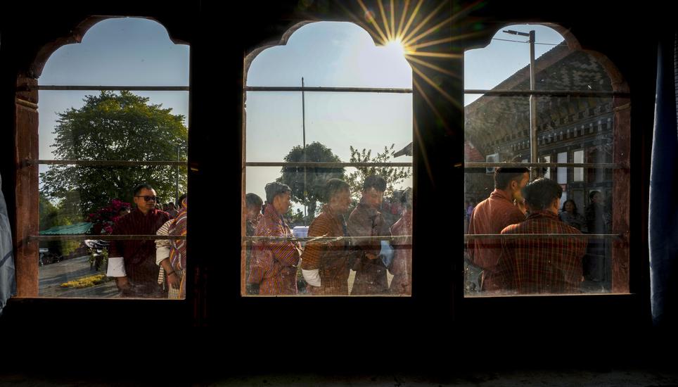 Bhutanese people in traditional attire queue up to cast their votes in the national elections in Deothang, Bhutan, Tuesday, Jan. 9, 2024. The landlocked country in the eastern Himalayan mountain range is electing a new Parliament, with the parties in cont