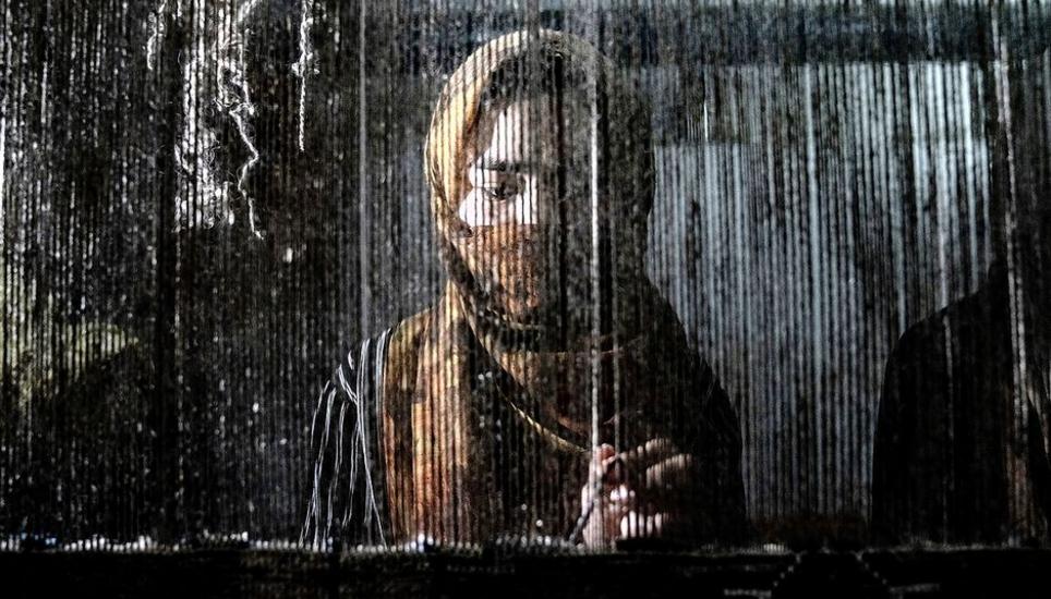 An Afghan woman weaves a carpet at a traditional carpet factory in Kabul, Afghanistan, Monday, March 6, 2023. After the Taliban came to power in Afghanistan, women have been deprived of many of their basic rights. (AP Photo/Ebrahim Noroozi)