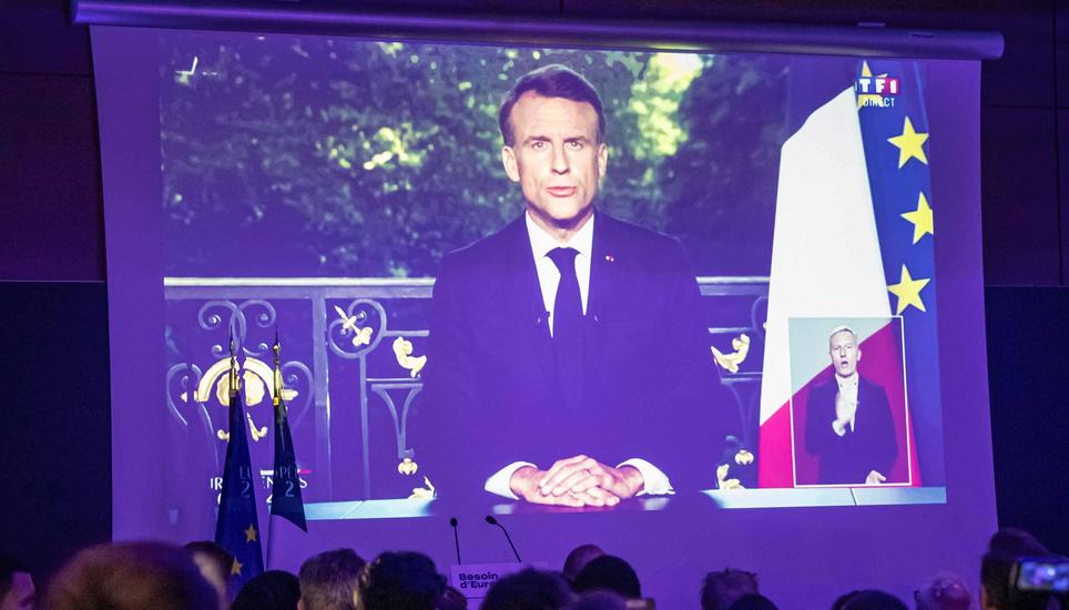 epa11400832 Supporters of presidential party RE Renaissance watch French President Emmanuel Macron?s speech displayed on the screen at the electoral party after the announcement of the results in Paris, France, 09 June 2024, after the first results of the