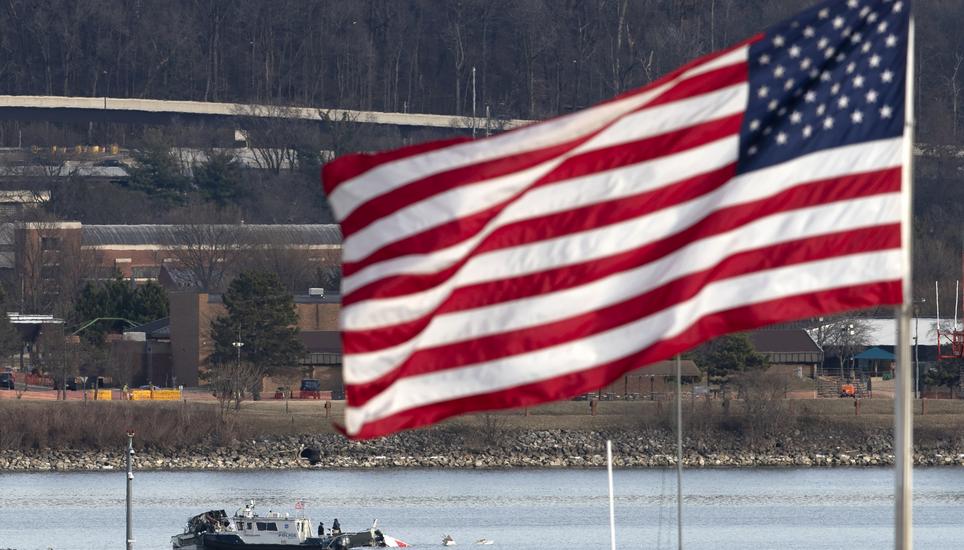 A police boat is seen around a wreckage site in the Potomac River from Ronald Reagan Washington National Airport, Thursday, Jan. 30, 2025, in Arlington, Va. (AP Photo/Jose Luis Magana)