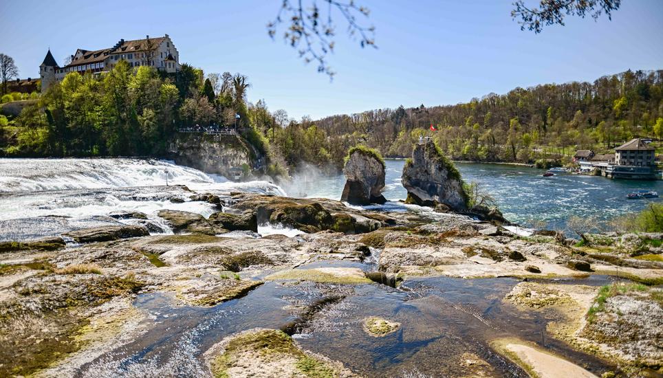 Touristen besuchen den Rheinfall bei sonnigem Wetter, wenig Wasser fliesst den Felsen herunter, am Dienstag, 08. April 2025. (Melanie Duchene / Schaffhauser Nachrichten)