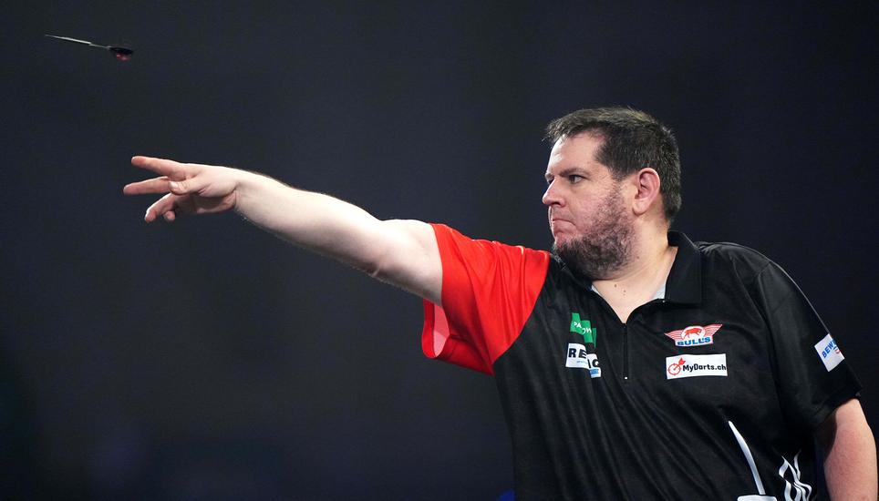 Switzerland's Stefan Bellmont in action against Australia's Damon Heta during the Round 2 match on day eleven of the World Darts Championship at the Alexandra Palace, in London, Sunday, Dec. 21, 2025. (Bradley Collyer/PA via AP)