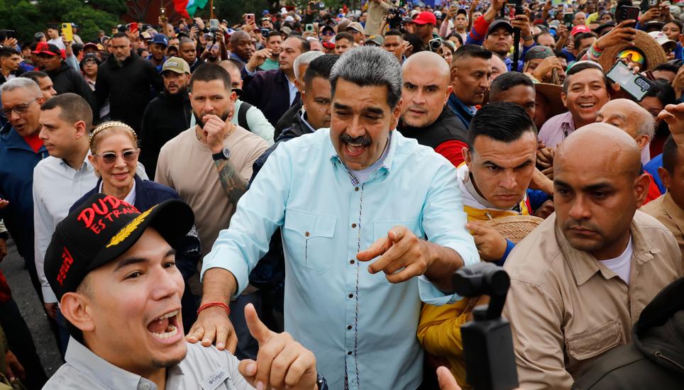 President Nicolas Maduro joins a rally marking the anniversary of the Battle of Santa Ines, which took place during Venezuela's 19th-century Federal War, in Caracas, Venezuela, Wednesday, Dec. 10, 2025. (AP Photo/Cristian Hernandez)