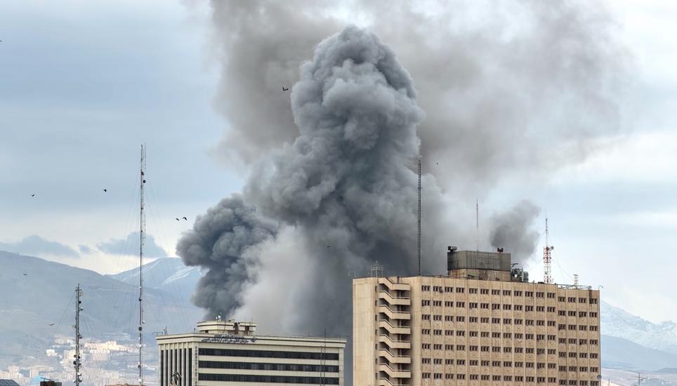 A plume of smoke rises after a strike in Tehran, Iran, Monday, March 2, 2026. (AP Photo/Mohsen Ganji)