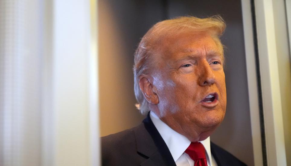 President Donald Trump speaks to reporters while traveling aboard Air Force One en route from Dover Air Force Base, Del., to Miami, Saturday, March 7, 2026. (AP Photo/Mark Schiefelbein)