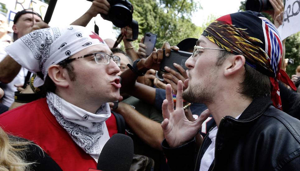 A counterprotester, left, confronts a professed supporter of President Donald Trump at a ï¿¢ï¾ï¾Free Speechï¿¢ï¾ï¾ rally by conservative activists on Boston Common, Saturday, Aug. 19, 2017, in Boston. (AP Photo/Mic