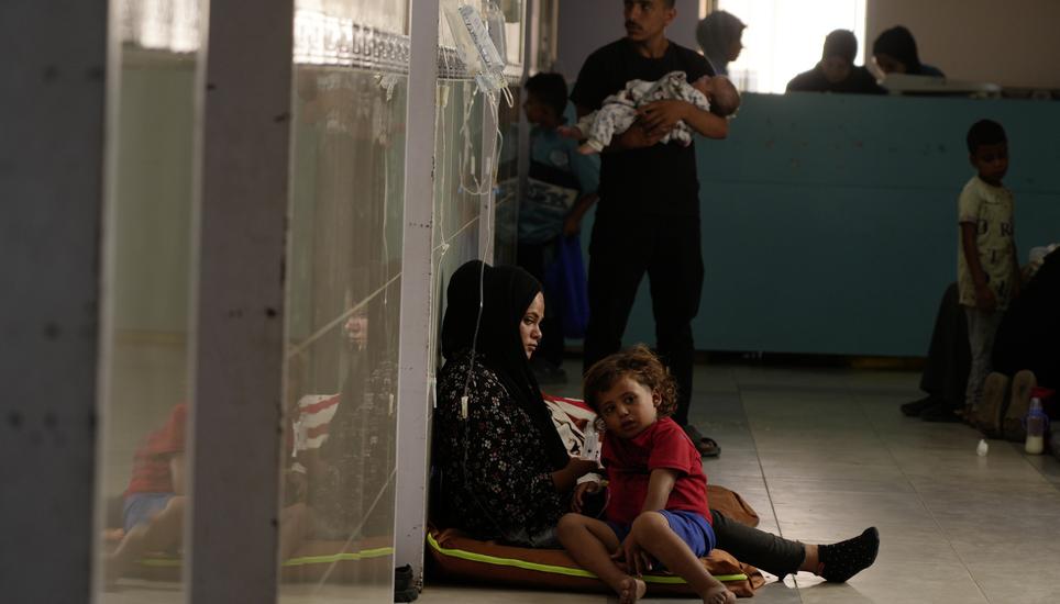 Palestinian children and their families rest in the corridors due to overcrowding in the pediatric department at Nasser Hospital in Khan Younis, southern Gaza Strip, Wednesday, Oct. 8, 2025. (AP Photo/Jehad Alshrafi)