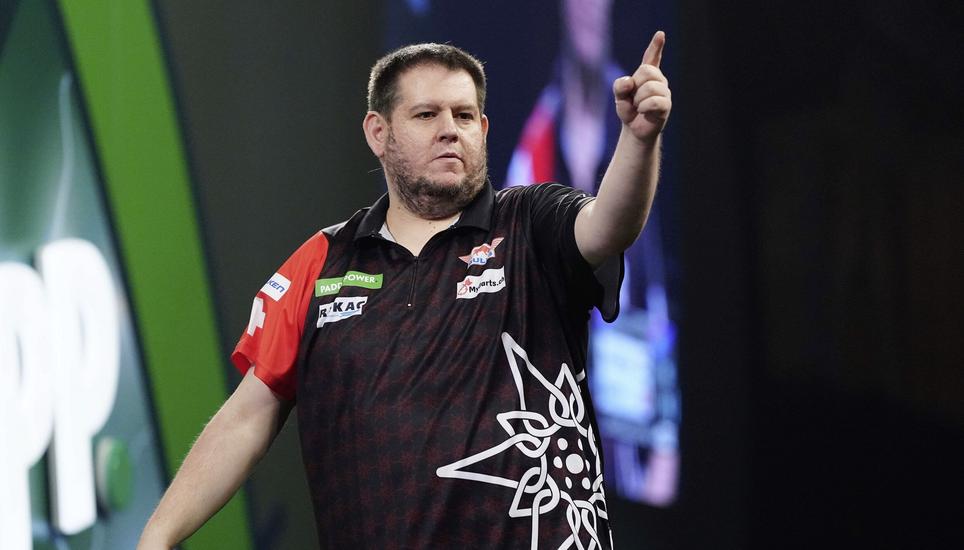 Stefan Bellmont plays his match against Raymond van Barneveld on day seven of the Paddy Power World Darts Championship at the Alexandra Palace in London, Wednesday, Dec. 17, 2025. (Bradley Collyer/PA via AP)