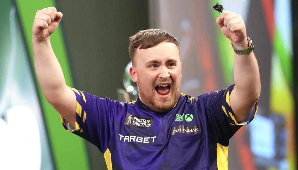 Luke Littler of England celebrates after winning the final against Michael van Gerwen of the Netherlands at the World Darts Championship at Alexandra Palace in London, Friday, Jan. 3, 2025. (AP Photo/Kirsty Wigglesworth)