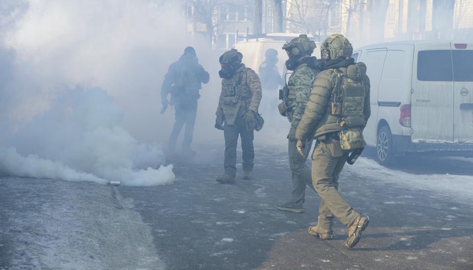 Immigration and Customs Enforcement agents walk through a cloud of their own tear gas at the scene where federal agents fatally shot Alex Pretti in Minneapolis, Minn., on Saturday, Jan. 24, 2026. (Aaron Nesheim/Sahan Journal/Catchlight Local via AP)