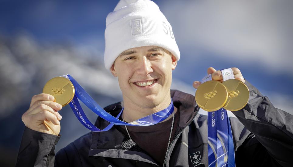 Gold medalist Franjo von Allmen of Switzerland poses for photographers with his three gold medals during a photocall outside the Swiss team hotel at the 2026 Olympic Winter Games at the Stelvio Ski centre in Bormio, Italy, on Thursday, February 12, 2026. 