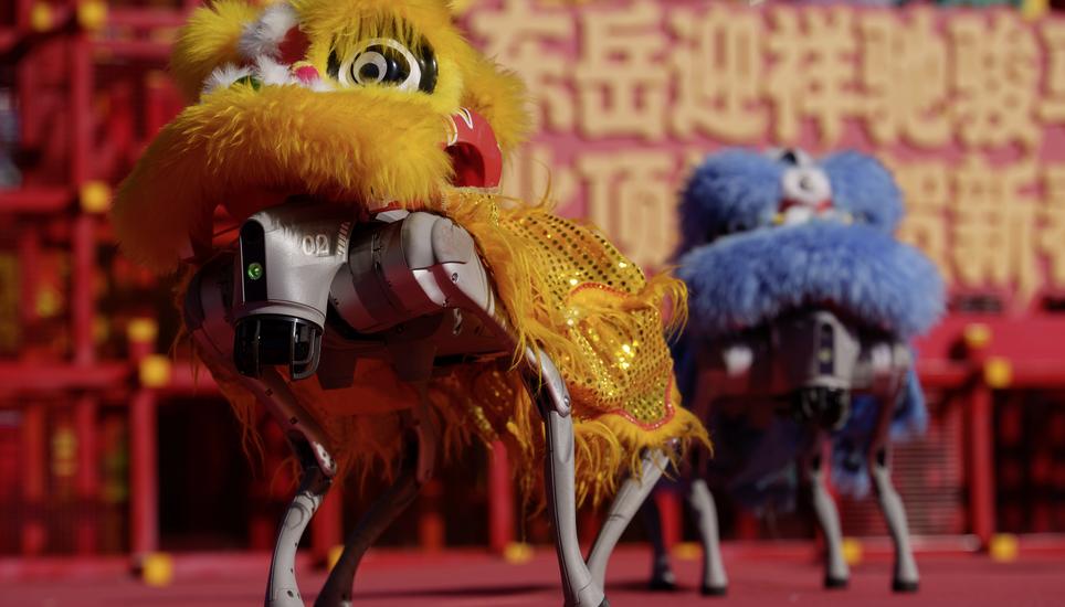 A quadruped robot fitted with a lion head performs during the second day of Lunar New Year celebrations at a temple fair in Beijing on Wednesday, Feb. 18, 2026. (AP Photo/Vincent Thian)