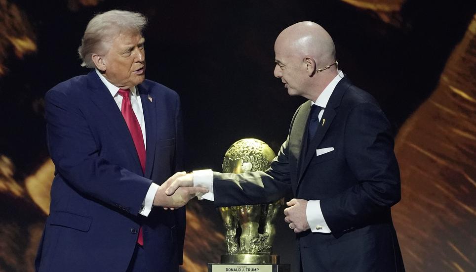 FILE - President Donald Trump shakes hands with FIFA President Gianni Infantino as he presented with the inaugural FIFA Peace Prize during the 2026 FIFA World Cup draw at the Kennedy Center, Dec. 5, 2025, in Washington. (AP Photo/Evan Vucci, File)