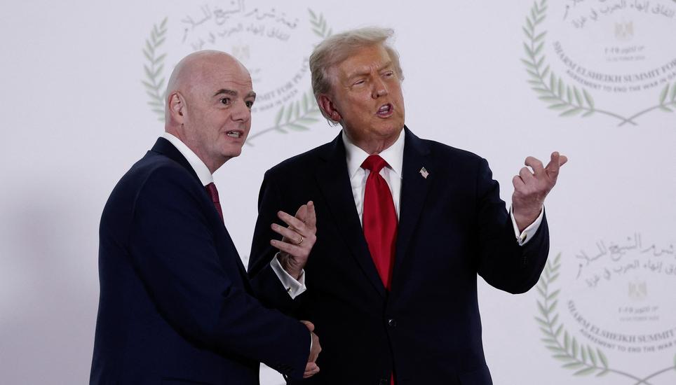 President Donald Trump and FIFA president Gianni Infantino pose for a photo in Sharm el-Sheikh, Egypt, Monday, Oct. 13, 2025. (Suzanne Plunkett, Pool Photo via AP)