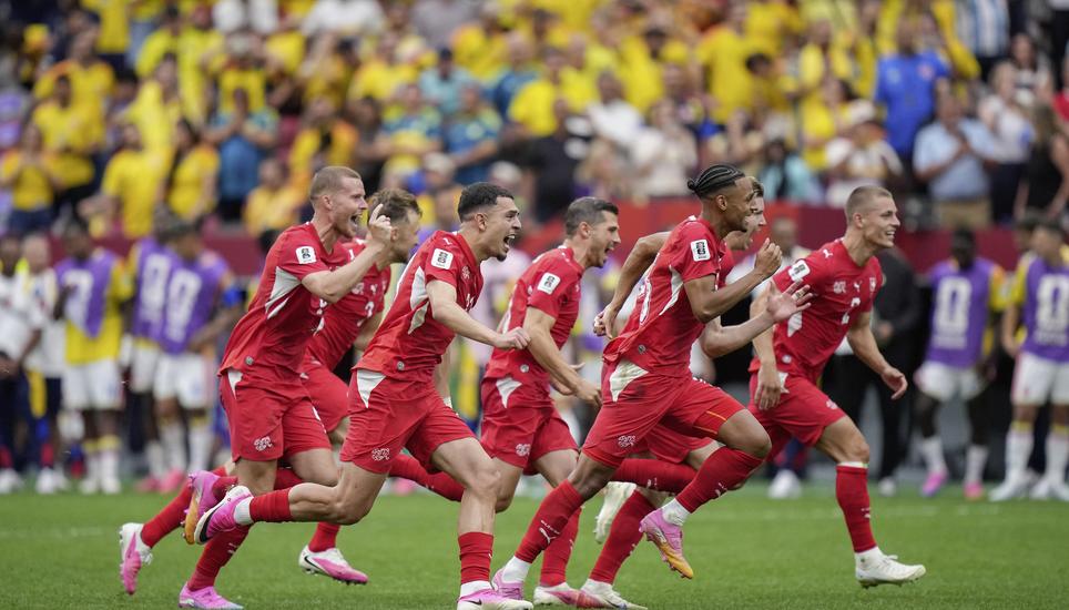 Switzerland players celebrate after defeating Colombia in a penalty shootout in the World Cup round of 16 soccer match between Switzerland and Colombia in Vancouver, British Columbia, Tuesday, July 7, 2026. (Darryl Dyck/The Canadian Press via AP)