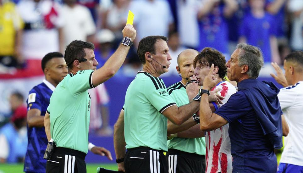Referee Ilgiz Tantashev, of Uzbekistan, a yellow card to a member of the Paraguayan team after the end of the World Cup round of 16 soccer match between Paraguay and France in Philadelphia, Saturday, July 4, 2026. (AP Photo/Derik Hamilton)
