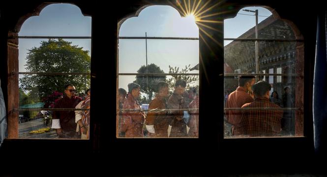 Bhutanese people in traditional attire queue up to cast their votes in the national elections in Deothang, Bhutan, Tuesday, Jan. 9, 2024. The landlocked country in the eastern Himalayan mountain range is electing a new Parliament, with the parties in cont