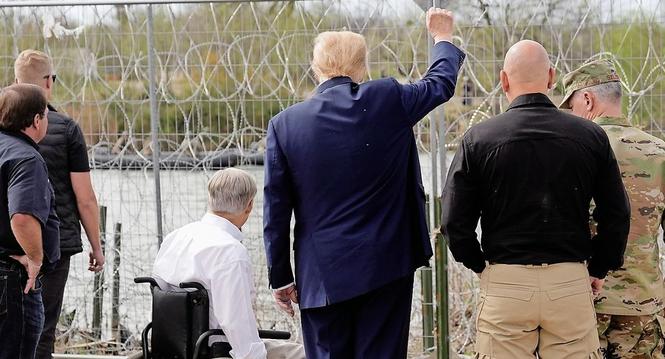 Republican presidential candidate former President Donald Trump gestures to people across the Rio Grande in Mexico at Shelby Park during a visit to the U.S.-Mexico border, Thursday, Feb. 29, 2024, in Eagle Pass, Texas. (AP Photo/Eric Gay)