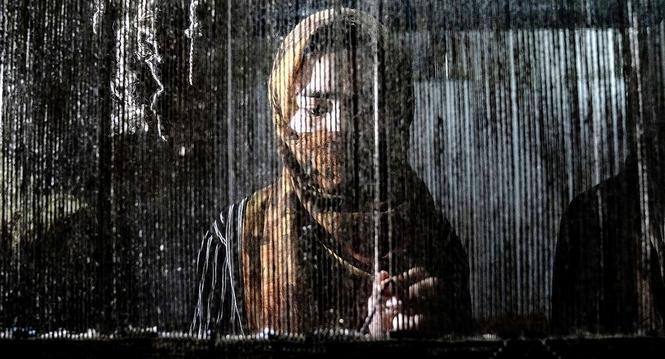 An Afghan woman weaves a carpet at a traditional carpet factory in Kabul, Afghanistan, Monday, March 6, 2023. After the Taliban came to power in Afghanistan, women have been deprived of many of their basic rights. (AP Photo/Ebrahim Noroozi)