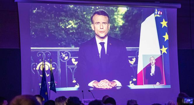 epa11400832 Supporters of presidential party RE Renaissance watch French President Emmanuel Macron?s speech displayed on the screen at the electoral party after the announcement of the results in Paris, France, 09 June 2024, after the first results of the