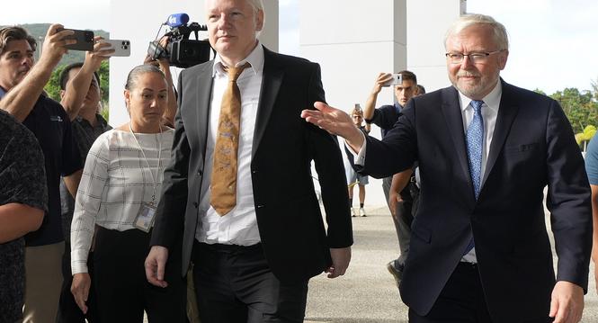 WikiLeaks founder Julian Assange, center, arrives at the United States courthouse where he is expected enter a plea deal in Saipan, Mariana Islands, Wednesday, June 26, 2024. (AP Photo/Eugene Hoshiko)