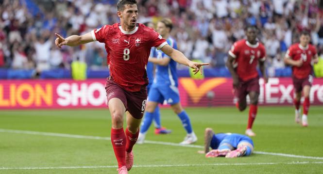 Switzerland's Remo Freuler (8) celebrates after scoring during a round of sixteen match between Switzerland and Italy at the Euro 2024 soccer tournament in Berlin, Germany, Saturday, June 29, 2024. (AP Photo/Matthias Schrader)