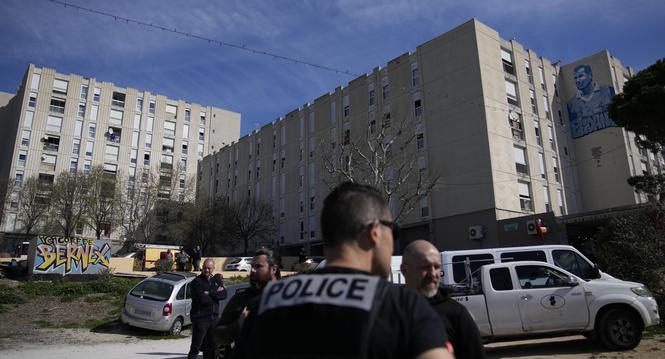 Police officers secure La Castellane district during a visit focusing on security and the fight against drug trafficking by French President Emmanuel Macron, Tuesday, March 19, 2024 in Marseille, southern France. (AP Photo/Christophe Ena)