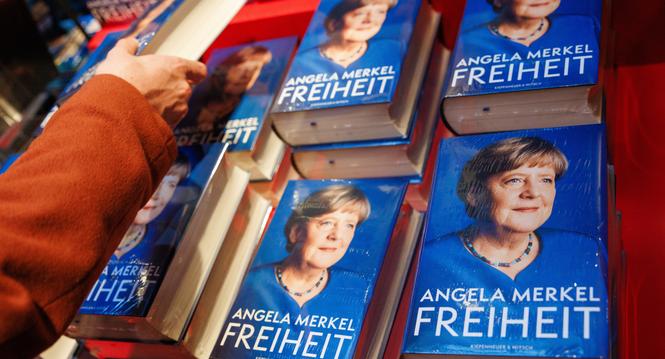 epa11741843 A customer reaches out for a hardcopy of the book 'Freedom. Memories 1954 - 2021' of former German Chancellor Angela Merkel on display at the Dussmann media store in Berlin, Germany, 26 November 2024. Merkel's political memoir were published o
