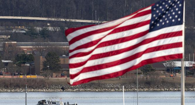 A police boat is seen around a wreckage site in the Potomac River from Ronald Reagan Washington National Airport, Thursday, Jan. 30, 2025, in Arlington, Va. (AP Photo/Jose Luis Magana)