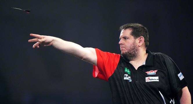Switzerland's Stefan Bellmont in action against Australia's Damon Heta during the Round 2 match on day eleven of the World Darts Championship at the Alexandra Palace, in London, Sunday, Dec. 21, 2025. (Bradley Collyer/PA via AP)