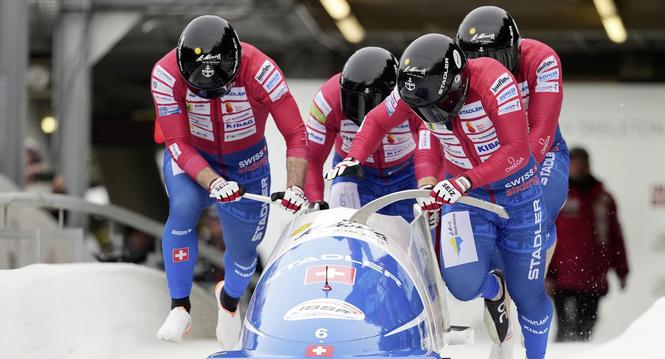Cedric Follador, Nicola Mariani, Omar Voegele and Dominik Schlaepfer, of Switzerland, compete in the 4-man bobsleigh race at the Bobsleigh World Cup in Innsbruck, Austria, Sunday, Nov. 30, 2025. (AP Photo/Matthias Schrader)