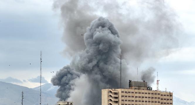 A plume of smoke rises after a strike in Tehran, Iran, Monday, March 2, 2026. (AP Photo/Mohsen Ganji)