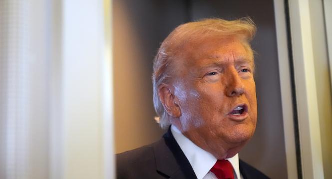 President Donald Trump speaks to reporters while traveling aboard Air Force One en route from Dover Air Force Base, Del., to Miami, Saturday, March 7, 2026. (AP Photo/Mark Schiefelbein)