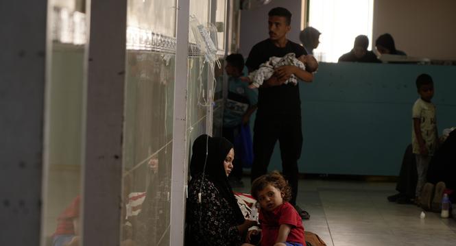 Palestinian children and their families rest in the corridors due to overcrowding in the pediatric department at Nasser Hospital in Khan Younis, southern Gaza Strip, Wednesday, Oct. 8, 2025. (AP Photo/Jehad Alshrafi)