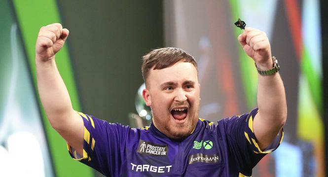 Luke Littler of England celebrates after winning the final against Michael van Gerwen of the Netherlands at the World Darts Championship at Alexandra Palace in London, Friday, Jan. 3, 2025. (AP Photo/Kirsty Wigglesworth)
