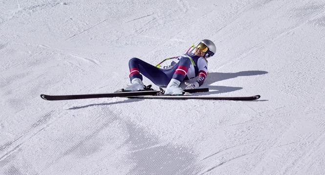 In this image taken from video provided by Olympic Broadcasting Services, OBS, United States' Lindsey Vonn lays on the course after crashing during an alpine ski women's downhill race, at the 2026 Winter Olympics, in Cortina d'Ampezzo, Italy, Sunday, Feb.
