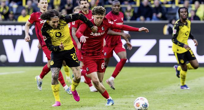 DORTMUND, GERMANY - APRIL 26: Fabio Silva (Borussia Dortmund, 21) and Rouven Vuk Tarnutzer (Freiburg, 69) battle for the ball during the Bundesliga [Bundesliga] match between Borussia Dortmund vs. Freiburg at Signal Iduna Park on matchday 31 of the 1. Bun