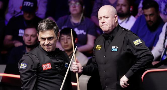 England's Ronnie O'Sullivan, left,  and Scotland's John Higgins during their match on day nine of the World Snooker Championship in Sheffield, England, Sunday, April 26, 2026. (Mike Egerton/PA via AP)