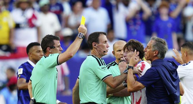 Referee Ilgiz Tantashev, of Uzbekistan, a yellow card to a member of the Paraguayan team after the end of the World Cup round of 16 soccer match between Paraguay and France in Philadelphia, Saturday, July 4, 2026. (AP Photo/Derik Hamilton)