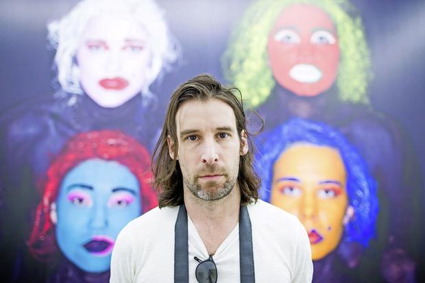 epa05352944 Swiss artist, Olaf Breuning, stands in front of his artwork 'Text Butt' (2015) in the NRW-Forum in Duesseldorf, Germany, 09 June 2016. The retrospective can be seen in Duesseldorf from 11 June until 21 August.  EPA/ROLF VENNENBERND